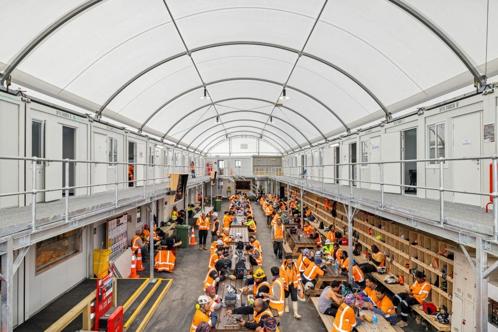 A group of construction workers have lunch inside a Pacific Portable Buildings site office village.